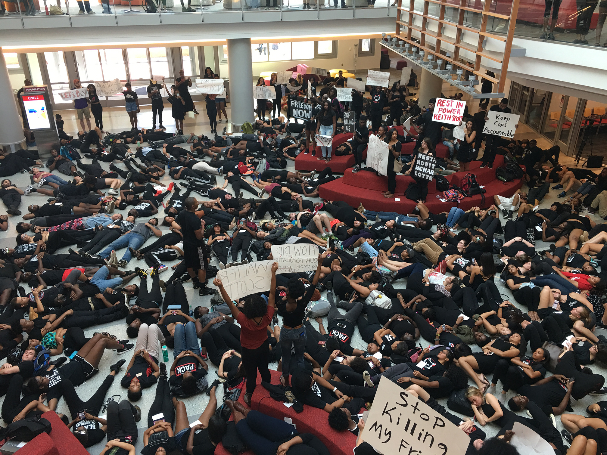 Photo of students participating in a die in at student center